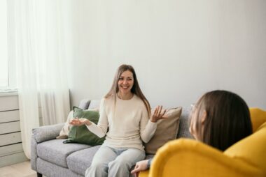 Client on couch with arms up during DBT therapy